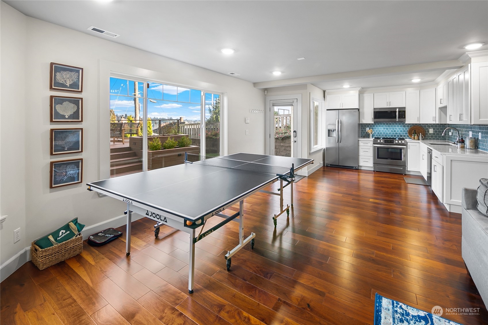 1020 West Ruffner Street Seattle, WA 98119 - Photo 26 of 39 a living room with stainless steel appliances dining table wooden floor and a large window