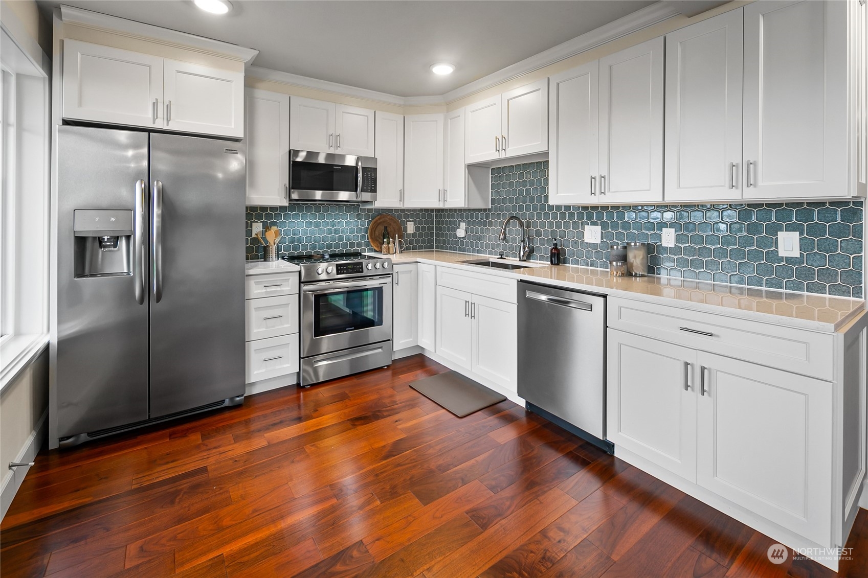 1020 West Ruffner Street Seattle, WA 98119 - Photo 28 of 39 a kitchen with granite countertop stainless steel appliances a refrigerator sink and microwave