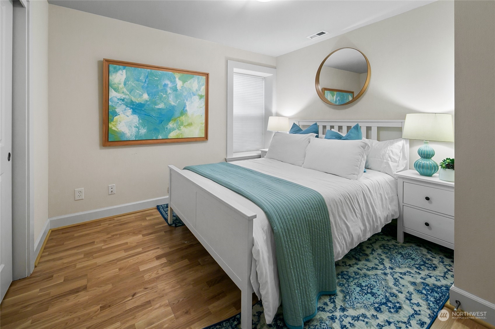 1020 West Ruffner Street Seattle, WA 98119 - Photo 32 of 39 a bedroom with a bed and painting on the wall