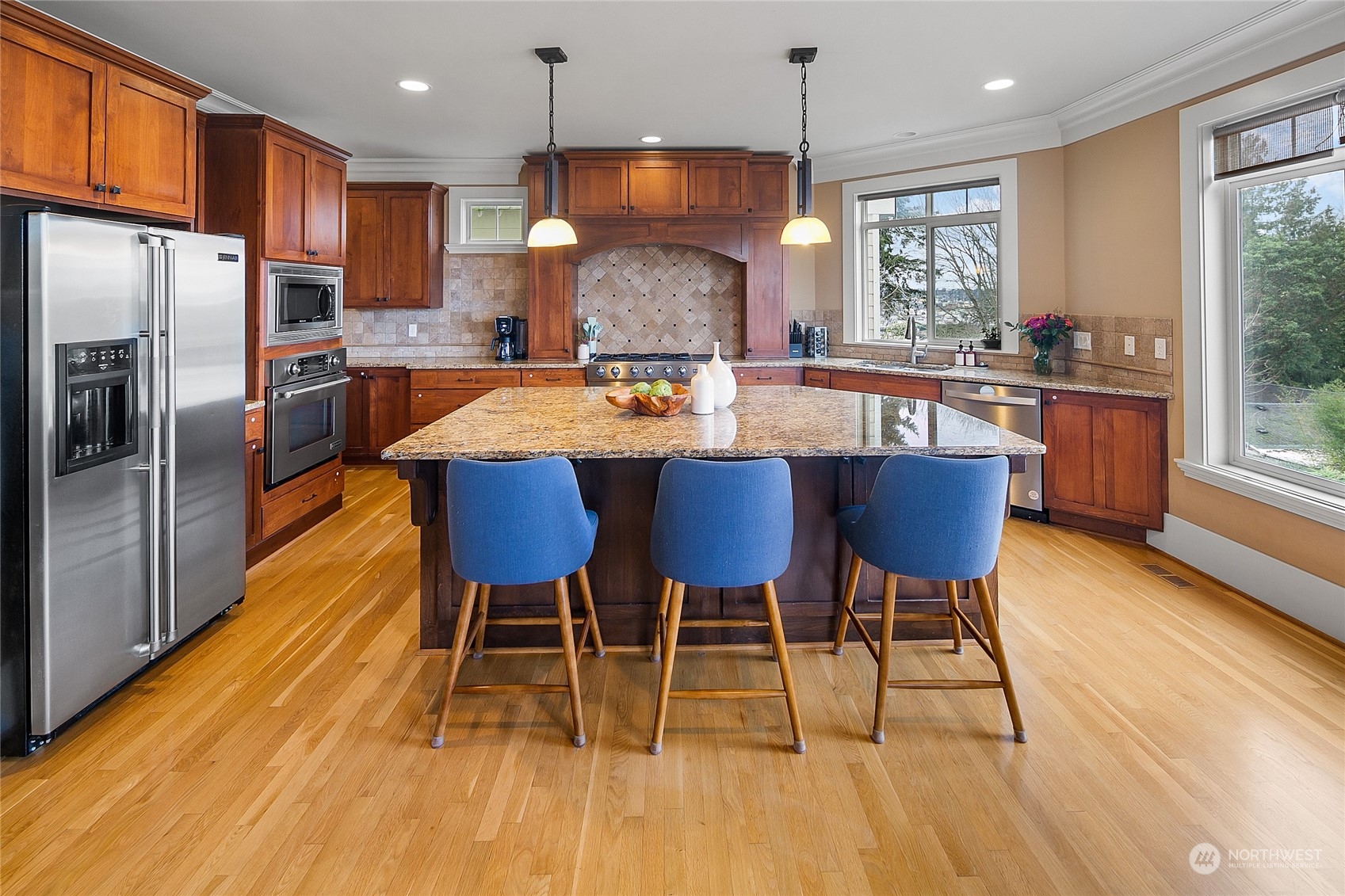 1020 West Ruffner Street Seattle, WA 98119 - Photo 4 of 39 a kitchen with stainless steel appliances granite countertop a stove a refrigerator a kitchen island a dining table and chairs