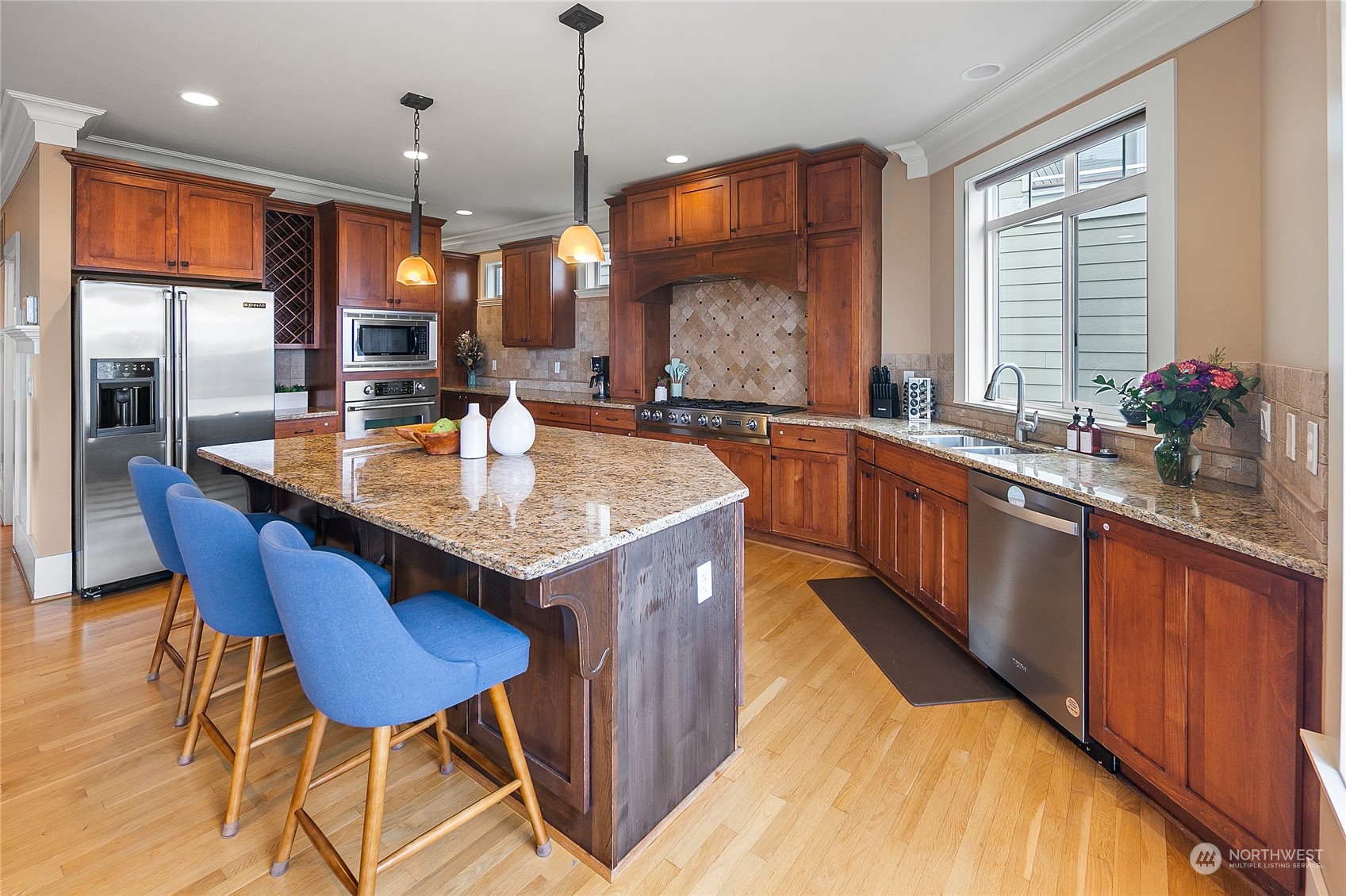1020 West Ruffner Street Seattle, WA 98119 - Photo 8 of 39 a kitchen with a stove a sink a counter space and dining table