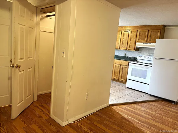a kitchen with a refrigerator and a stove top oven