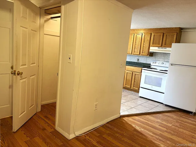 a kitchen with a refrigerator and a stove top oven