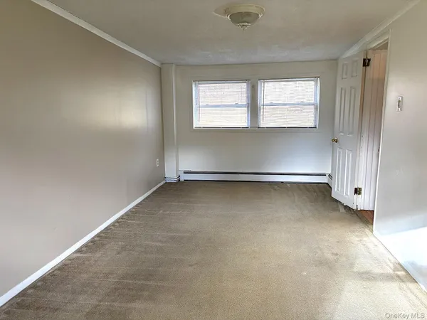 an empty room with a windows and closet