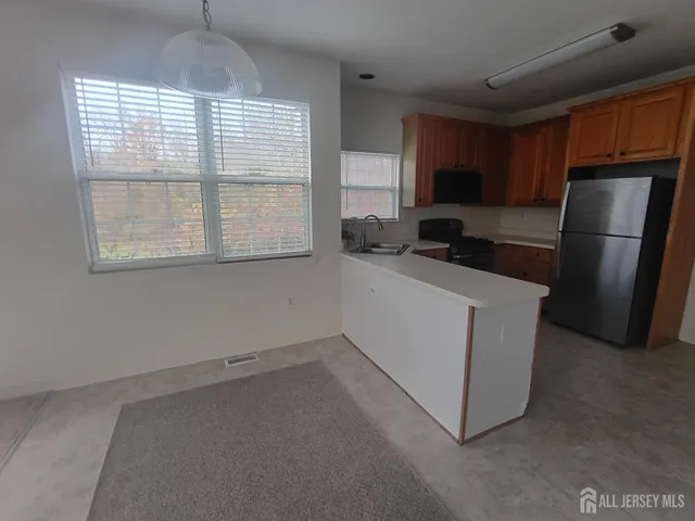 a kitchen with a refrigerator and a sink