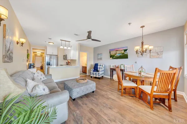 a living room with furniture dining table and a chandelier
