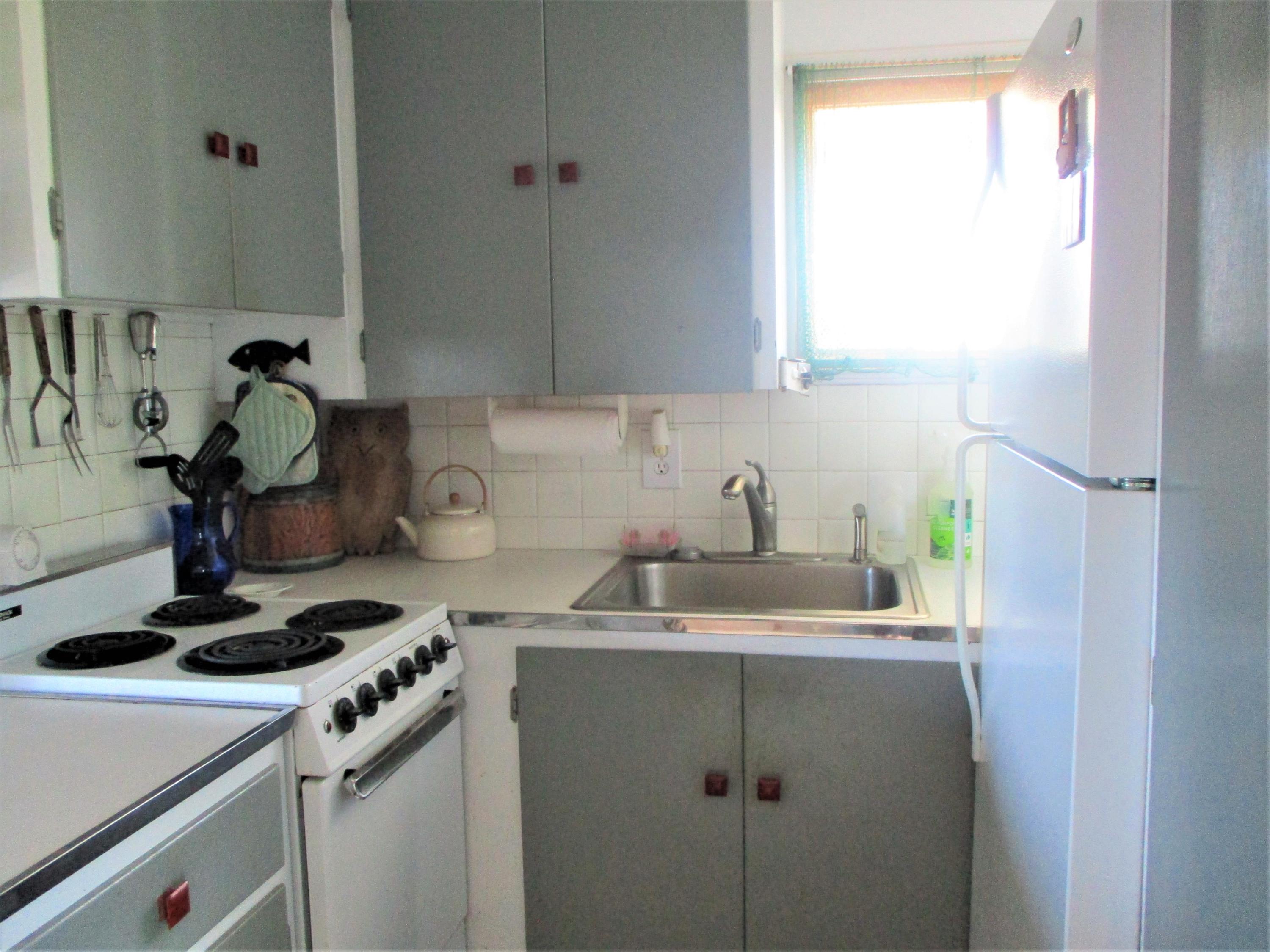 800 Ocean View Drive Wellfleet, MA 02667 - Photo 22 of 38 a kitchen with a sink cabinets and appliances