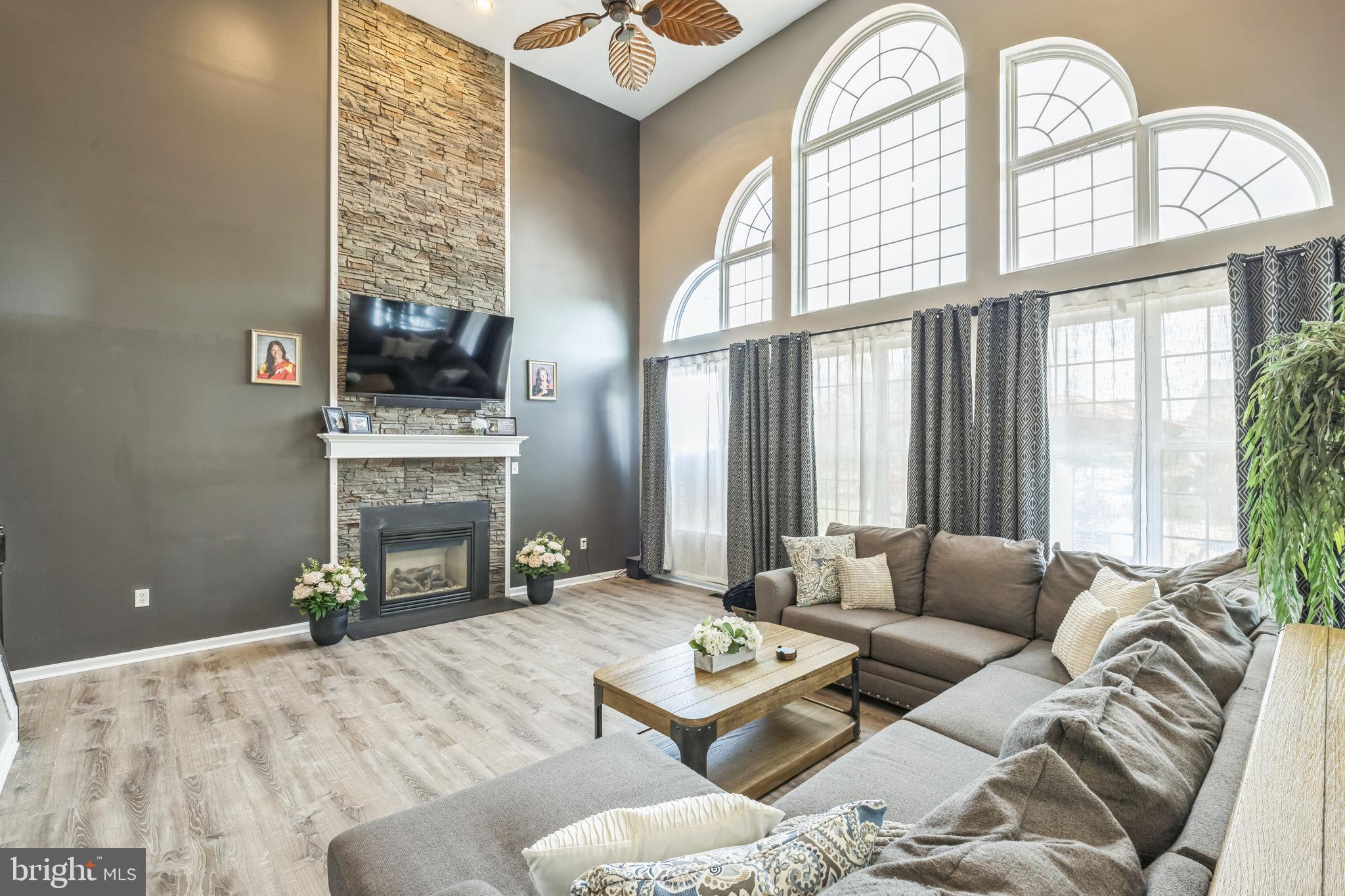 104 Abigail Lane Mickleton, NJ 08056 - Photo 17 of 75 a living room with furniture a fireplace and a flat screen tv
