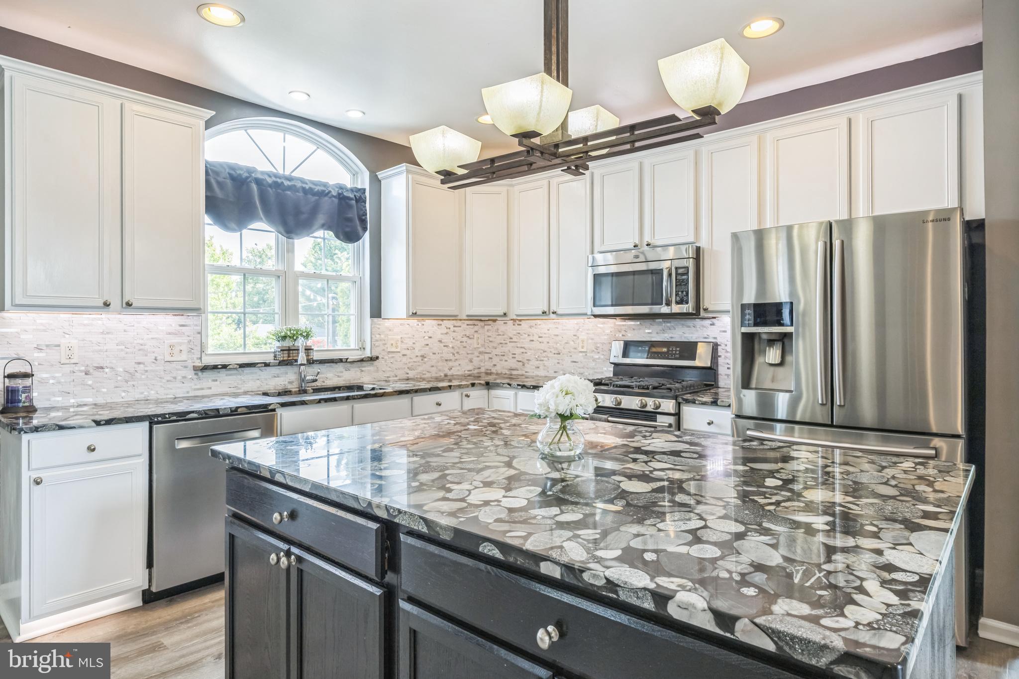 104 Abigail Lane Mickleton, NJ 08056 - Photo 27 of 75 a kitchen with kitchen island granite countertop a sink stove and refrigerator