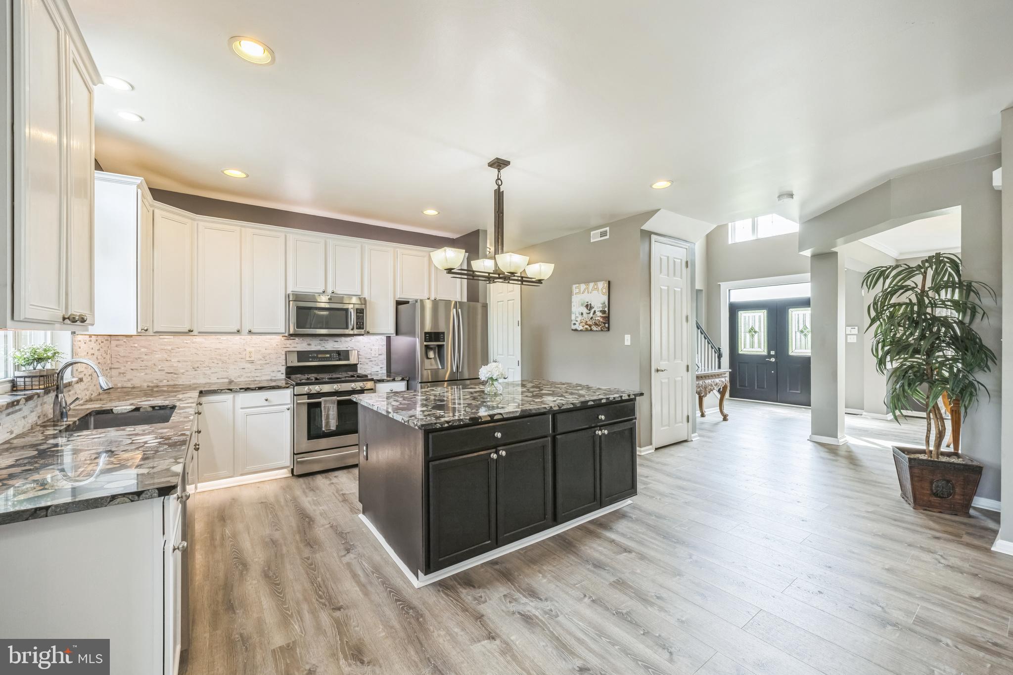 104 Abigail Lane Mickleton, NJ 08056 - Photo 29 of 75 a large kitchen with stainless steel appliances lots of counter space and wooden floor