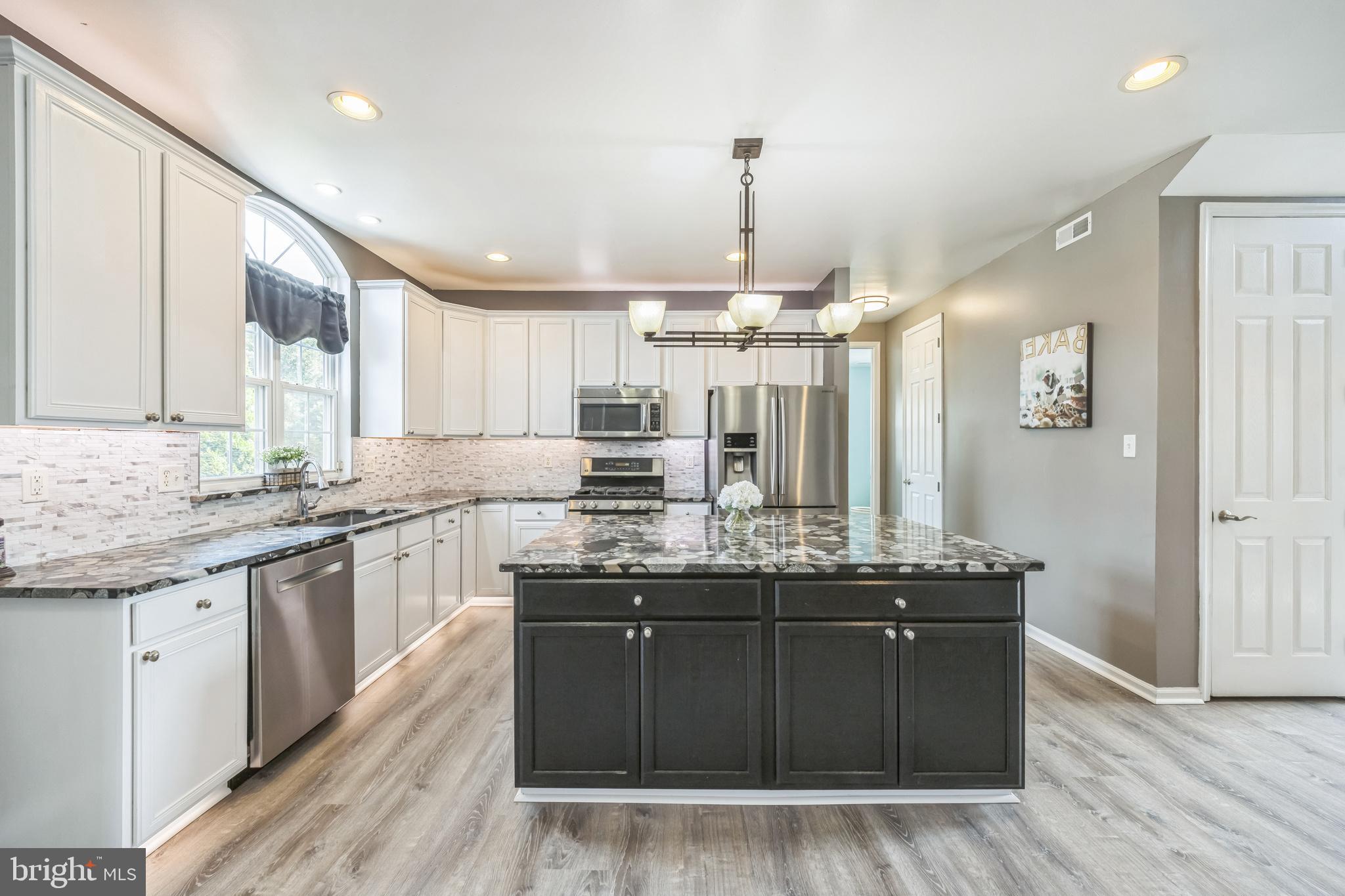 104 Abigail Lane Mickleton, NJ 08056 - Photo 30 of 75 a kitchen with granite countertop a sink cabinets and wooden floor