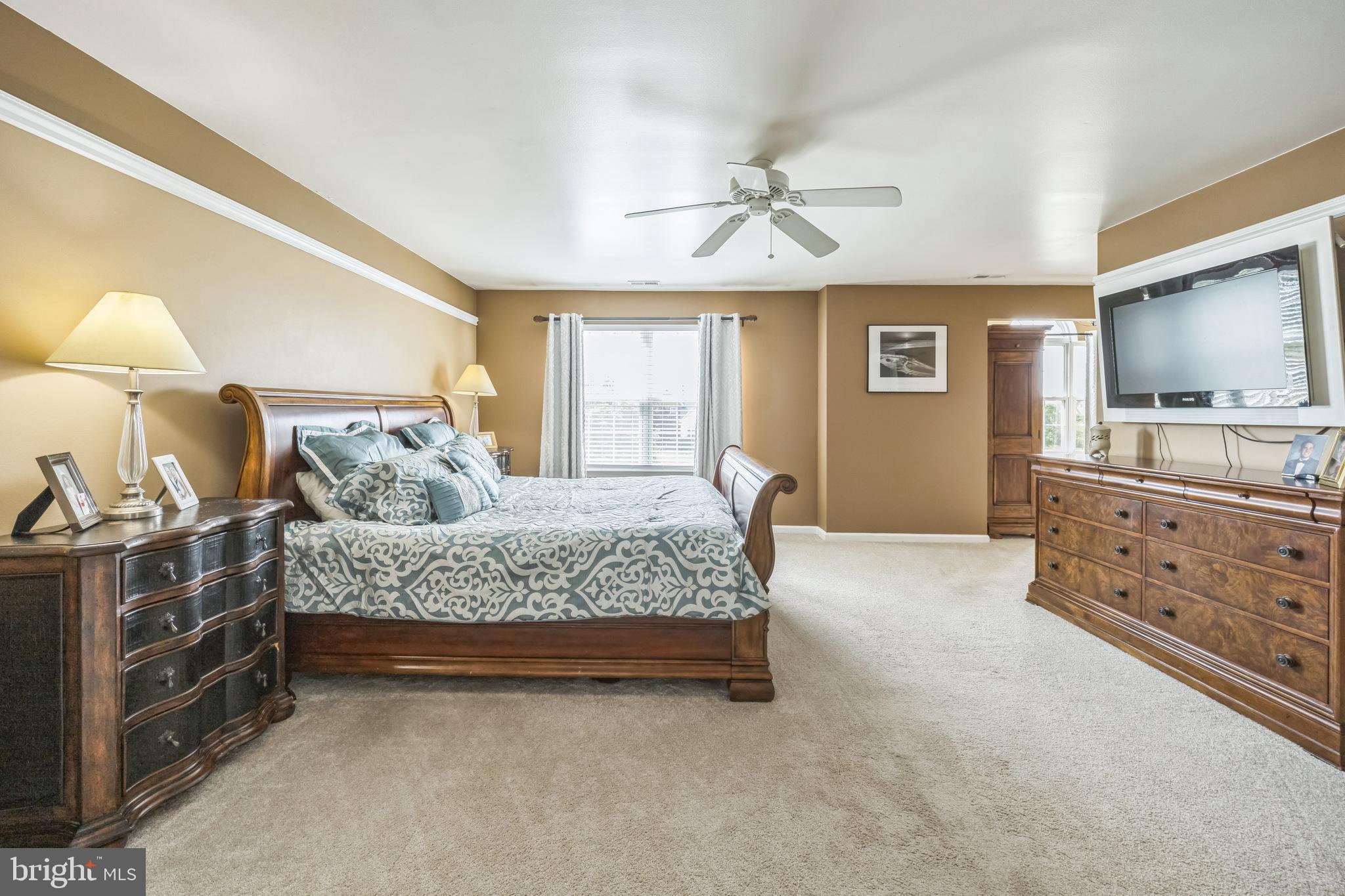 104 Abigail Lane Mickleton, NJ 08056 - Photo 35 of 75 a spacious bedroom with a bed and a chandelier