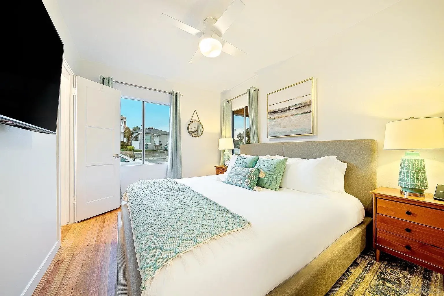 965 Rosecrans Street San Diego, CA 92106 - Photo 5 of 12 a bedroom with a bed and a chandelier