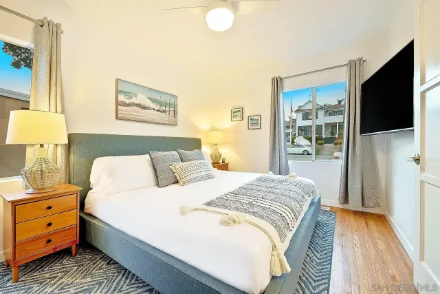 a bedroom with a bed and a tv on the dresser