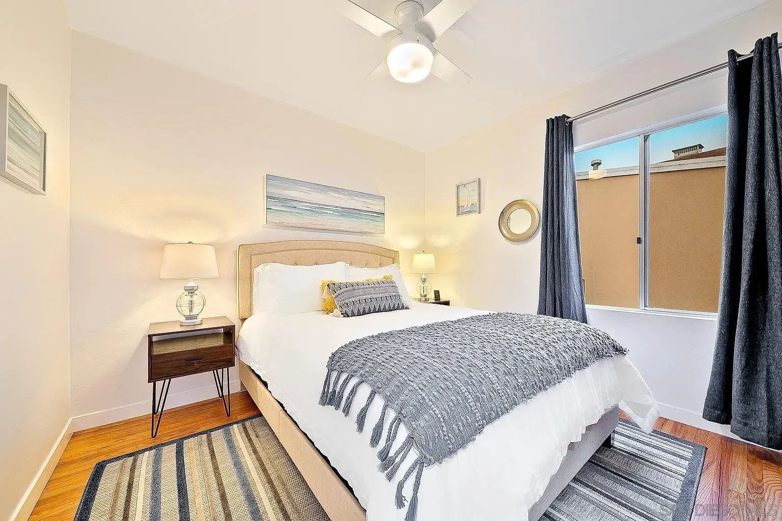 965 Rosecrans Street San Diego, CA 92106 - Photo 7 of 12 a bedroom with a bed and a window