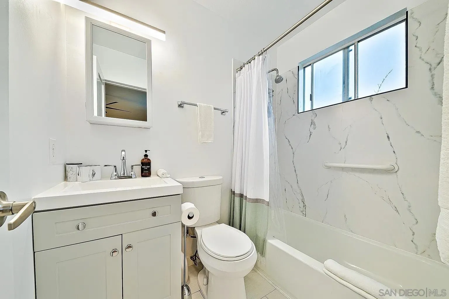 965 Rosecrans Street San Diego, CA 92106 - Photo 10 of 12 a bathroom with a sink toilet and shower