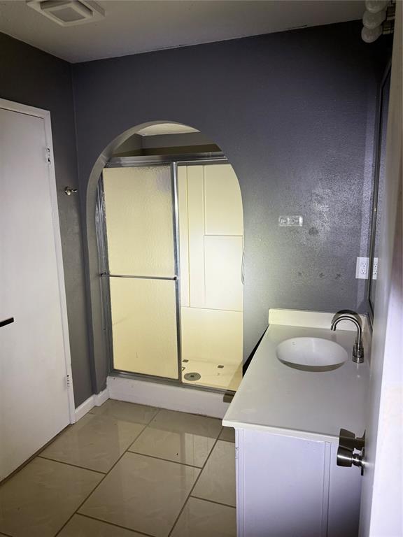 4601 Elm Ridge Lane Garland, TX 75044 - Photo 15 of 20 a bathroom with a granite countertop sink and a mirror