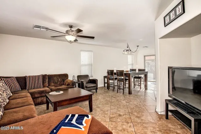 a living room with furniture a dining table and a fireplace
