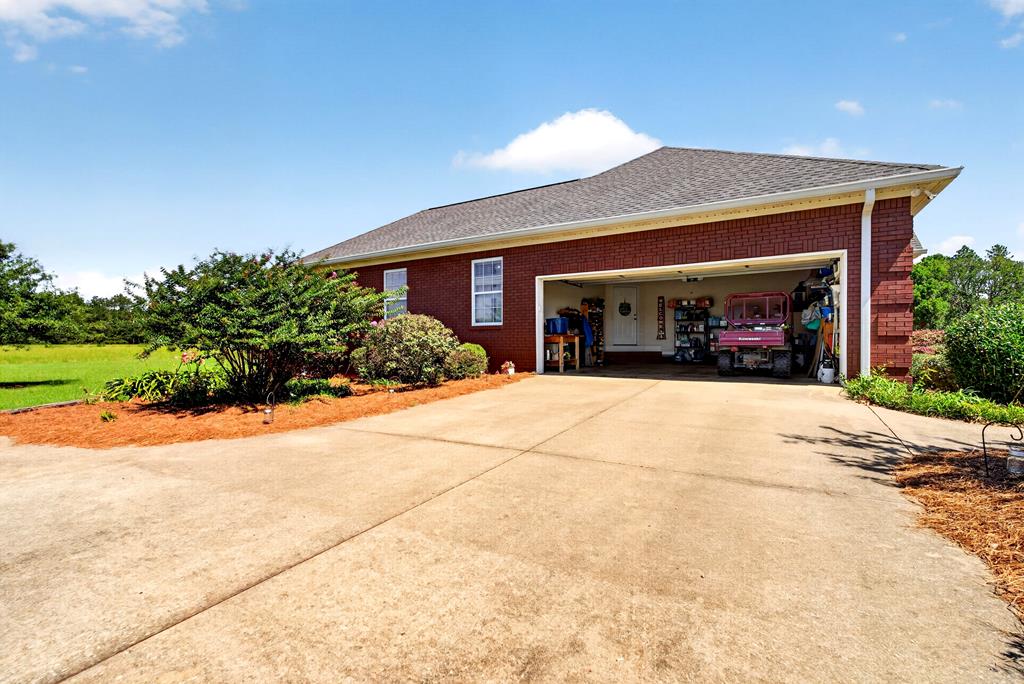 481 Sand Pit Road Mauk, GA 31058 - Photo 35 of 50 a front view of a house with a yard and garage