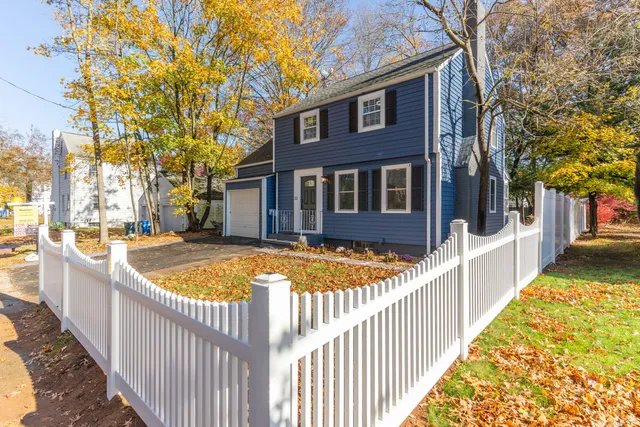 a view of a house with iron fence