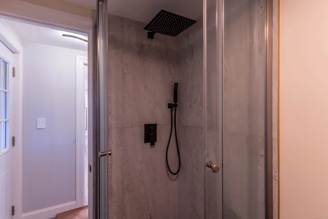 a bathroom with a glass shower door