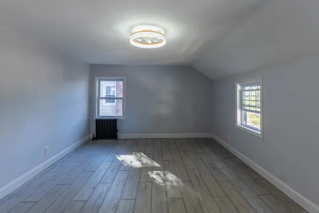 an empty room with windows and closet