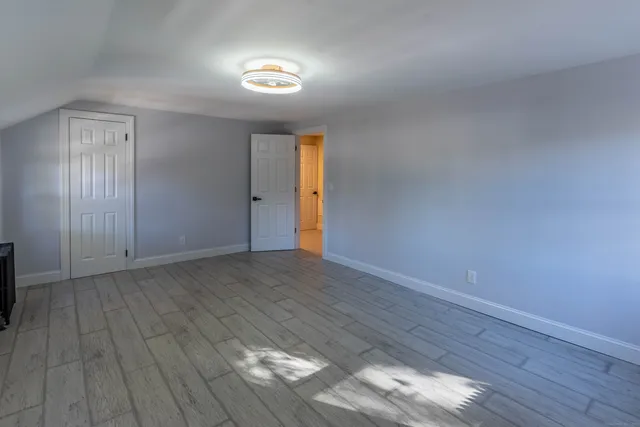 a view of an empty room and wooden floor