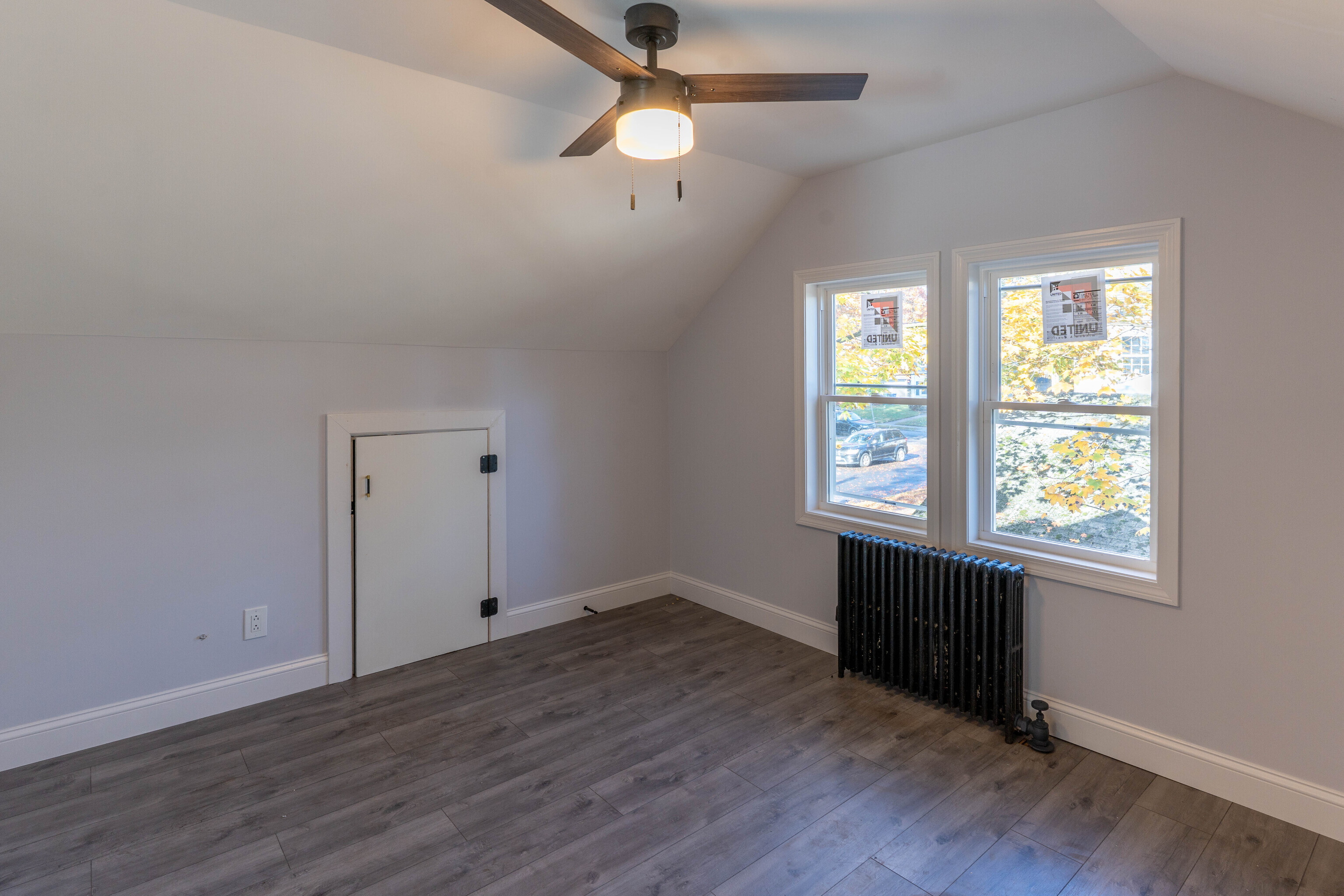 33 Bank Street Hamden, CT 06514 - Photo 17 of 32 an empty room with wooden floor chandelier fan and windows