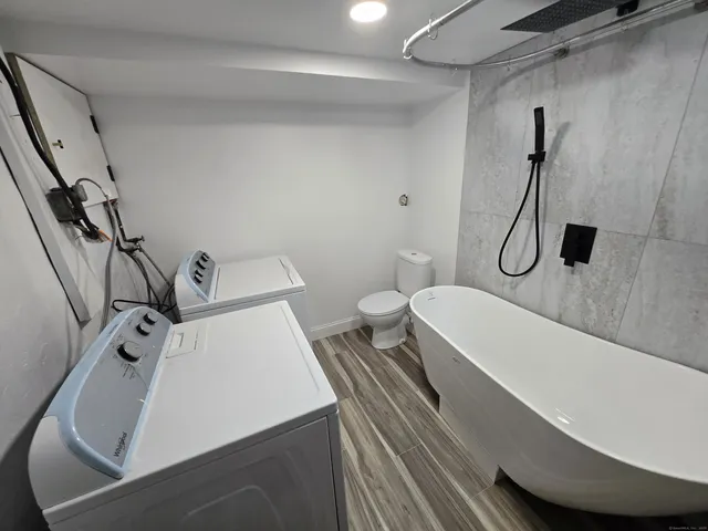 a bathroom with a sink toilet and shower