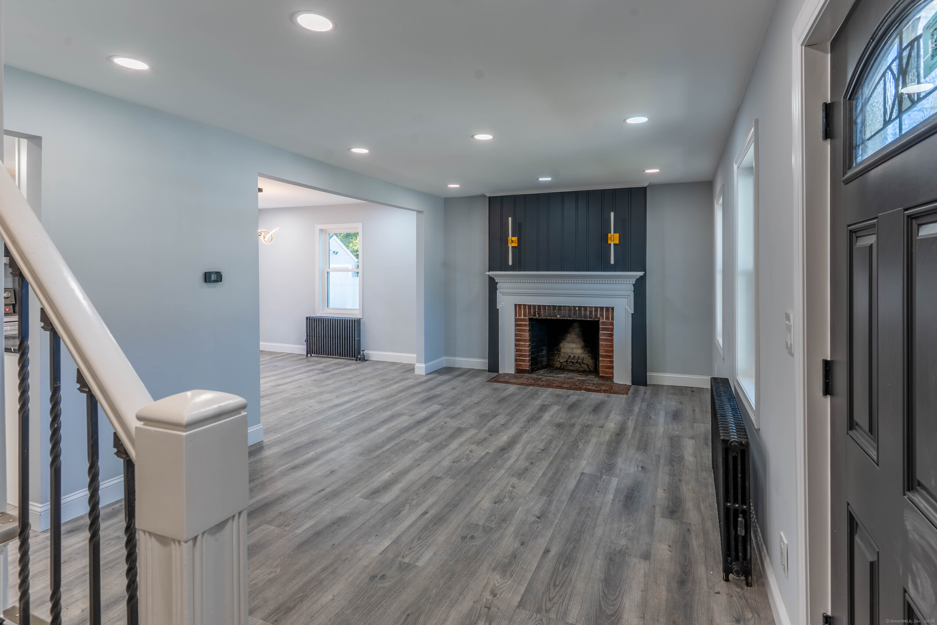 33 Bank Street Hamden, CT 06514 - Photo 2 of 32 a view of an empty room with wooden floor and a fireplace