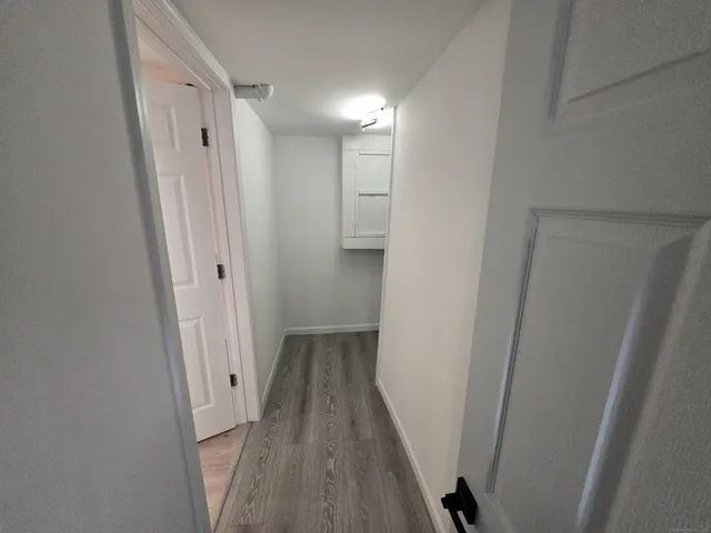 a view of a hallway with wooden floor