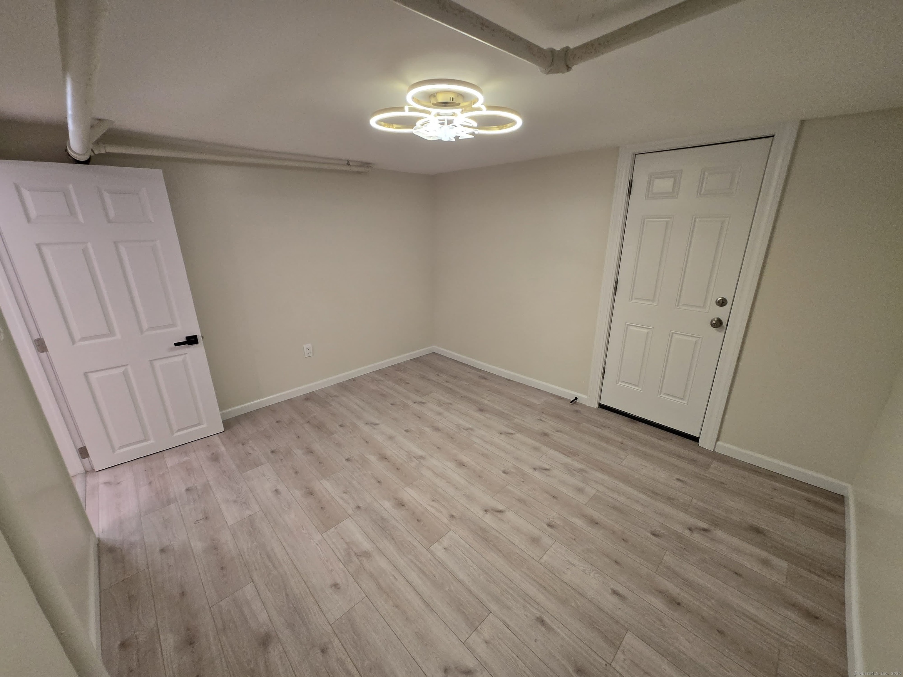 33 Bank Street Hamden, CT 06514 - Photo 25 of 32 a view of an empty room with wooden floor and a window