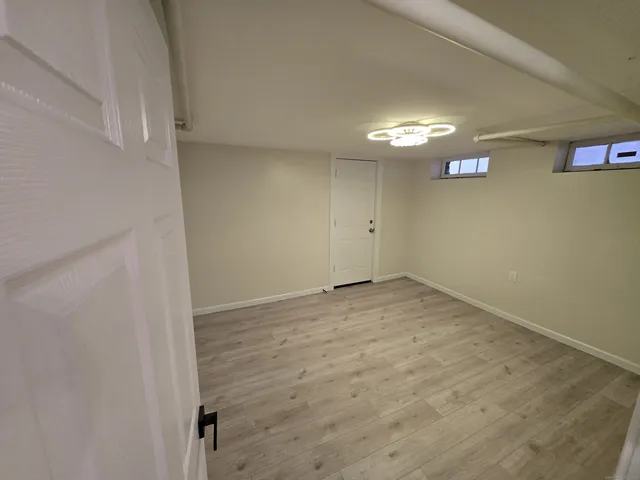 an empty room with a chair and a window