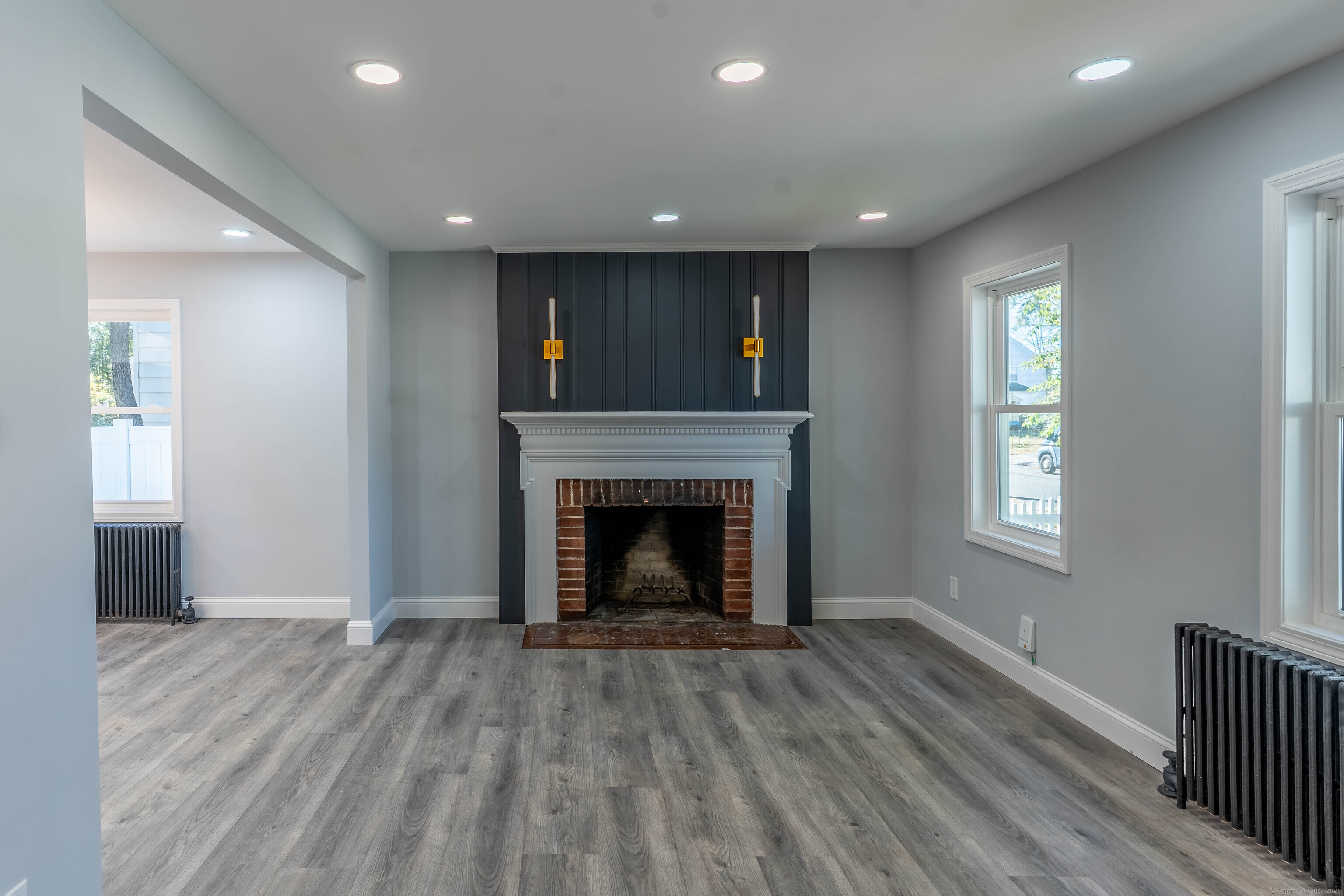 33 Bank Street Hamden, CT 06514 - Photo 3 of 32 a view of an empty room with wooden floor fireplace and a window
