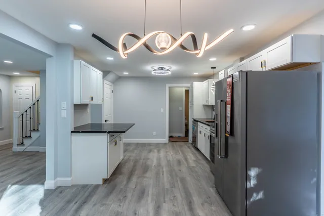 a kitchen with stainless steel appliances a refrigerator a sink and a stove