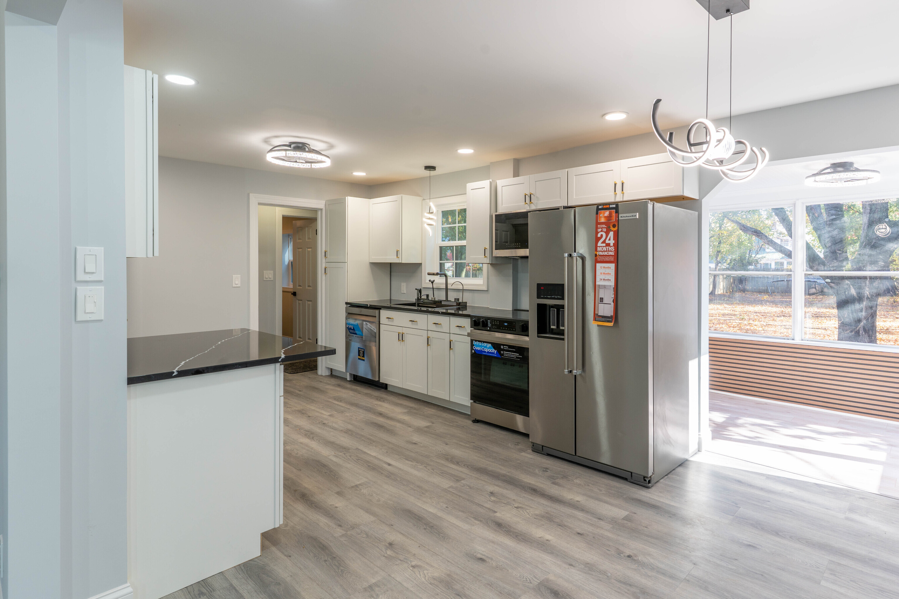 33 Bank Street Hamden, CT 06514 - Photo 6 of 32 a kitchen with stainless steel appliances granite countertop a refrigerator a oven a sink and white cabinets with wooden floor