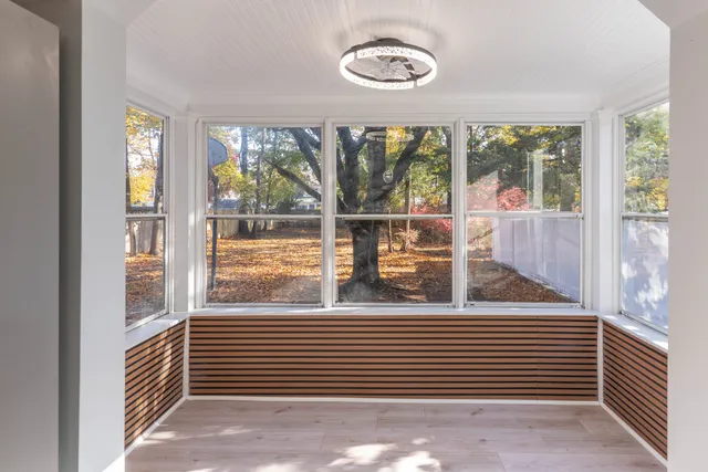 a view of a room that has a large window and a table
