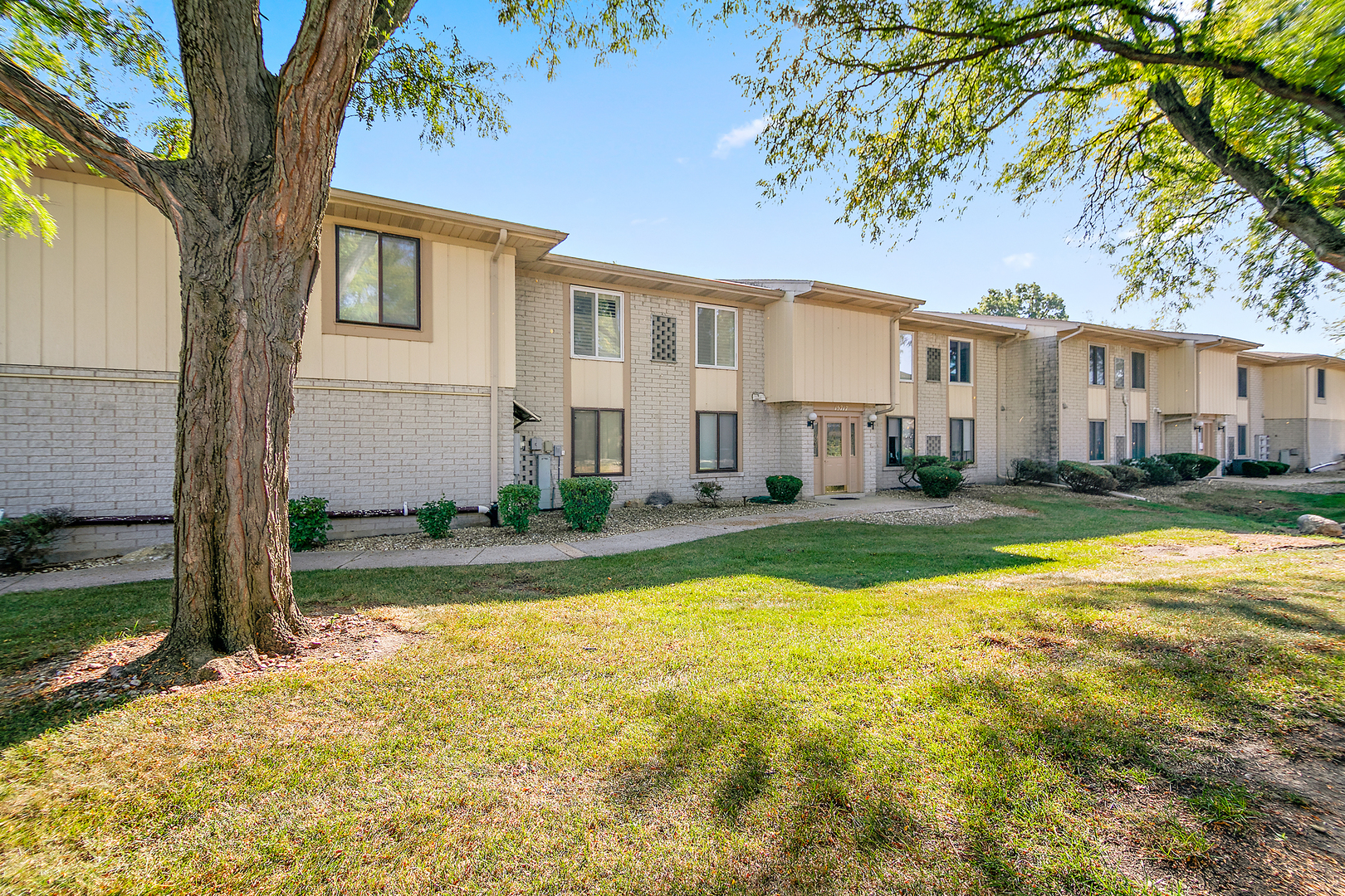 15717 Orlan Brook Drive, Unit 84 Orland Park, IL 60462 - Photo 1 of 18 a view of a house with swimming pool and a yard