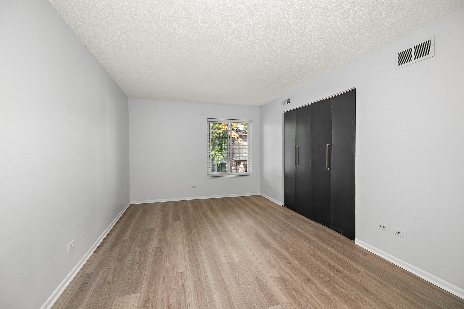 15717 Orlan Brook Drive, Unit 84 Orland Park, IL 60462 - Photo 11 of 18 an empty room with windows