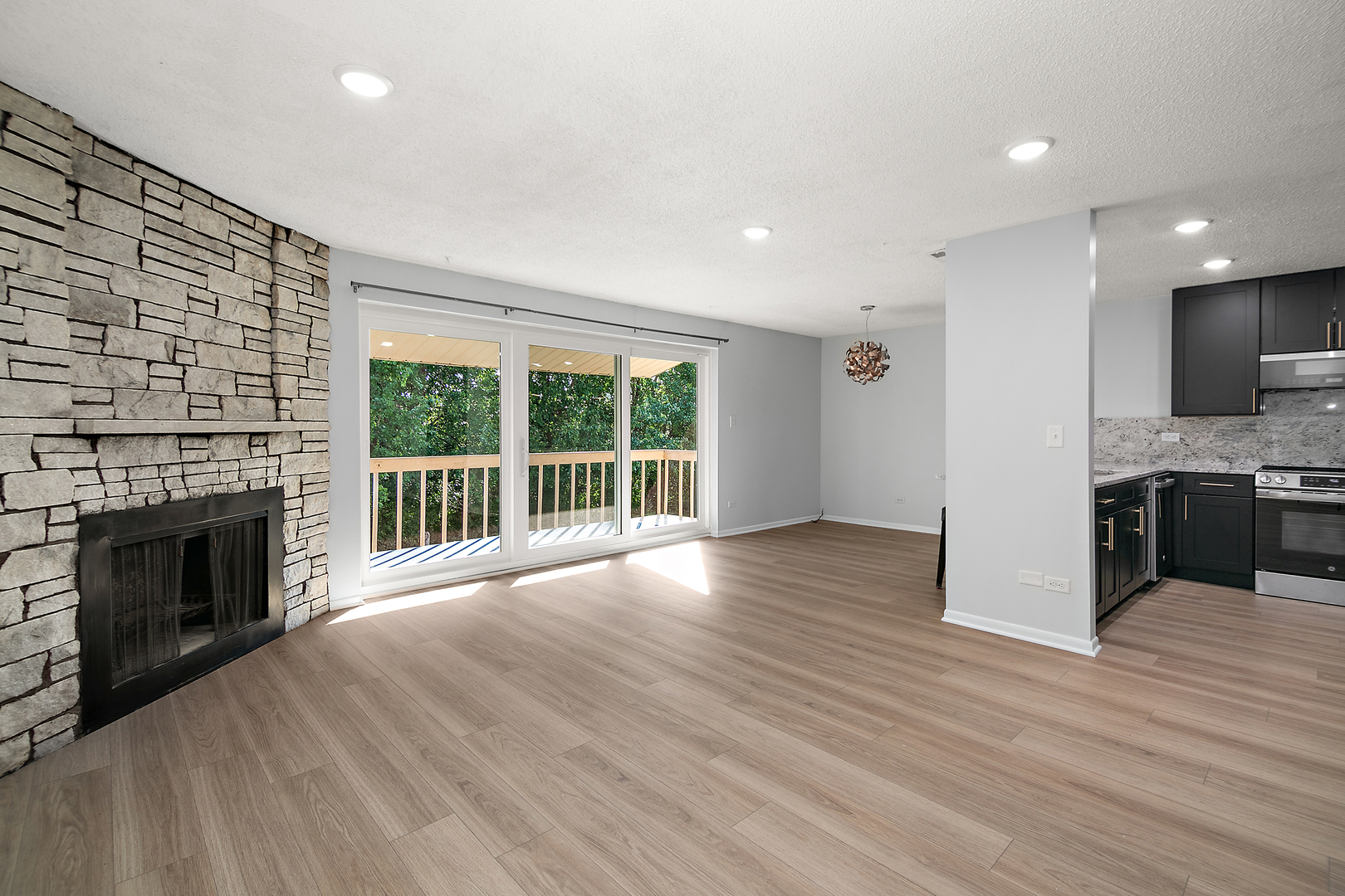 15717 Orlan Brook Drive, Unit 84 Orland Park, IL 60462 - Photo 3 of 18 a view of an empty room with wooden floor and a fireplace