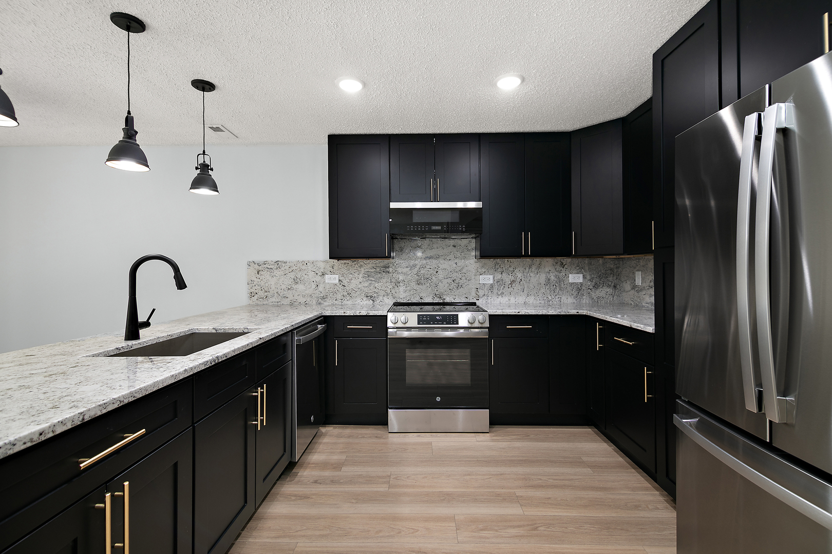 15717 Orlan Brook Drive, Unit 84 Orland Park, IL 60462 - Photo 6 of 18 a kitchen with stainless steel appliances granite countertop a sink stove and refrigerator