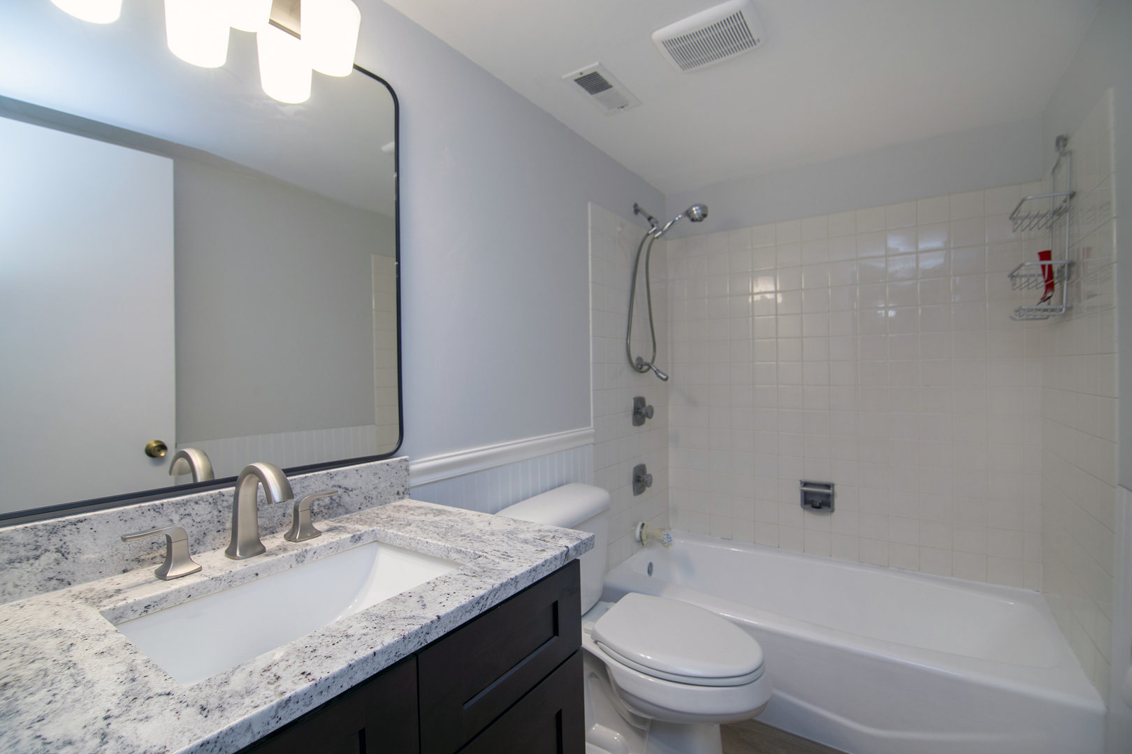 15717 Orlan Brook Drive, Unit 84 Orland Park, IL 60462 - Photo 9 of 18 a bathroom with a granite countertop sink a toilet and shower
