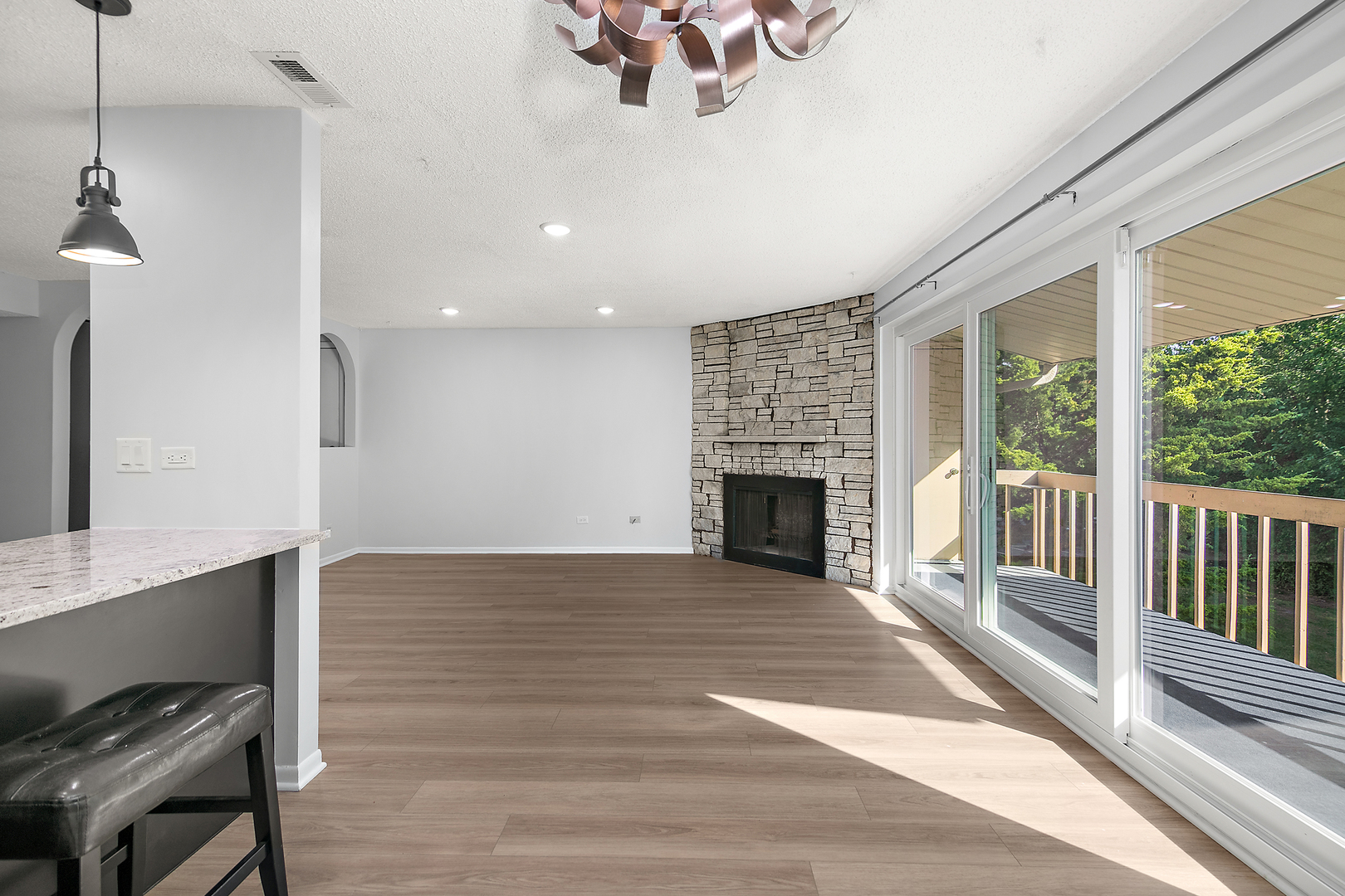 15717 Orlan Brook Drive, Unit 84 Orland Park, IL 60462 - Photo 10 of 18 a view of empty room with wooden floor and fireplace