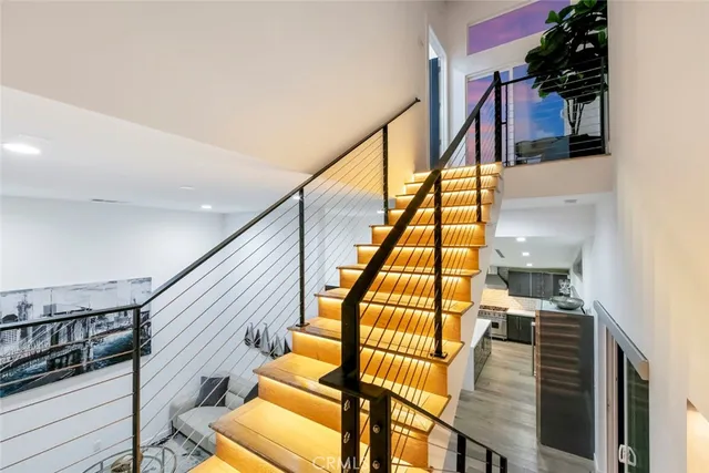 a kitchen with a table and a potted plant