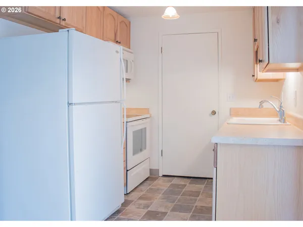 a white refrigerator freezer sitting inside of a kitchen
