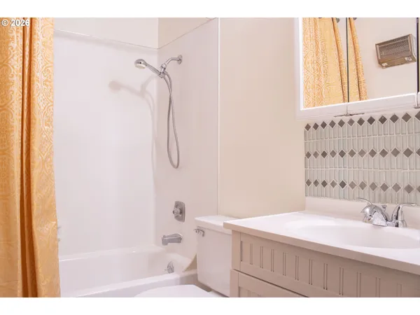 a bathroom with a bathtub a sink and a shower