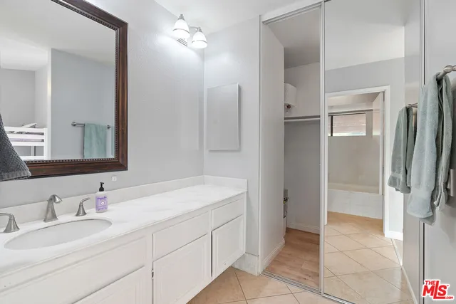 a bathroom with a double vanity sink mirror and shower