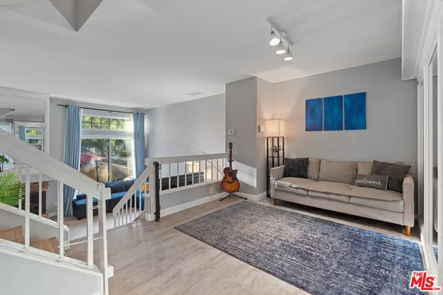 a living room with furniture and a book shelf