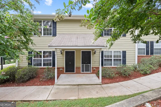 a front view of a house with garden