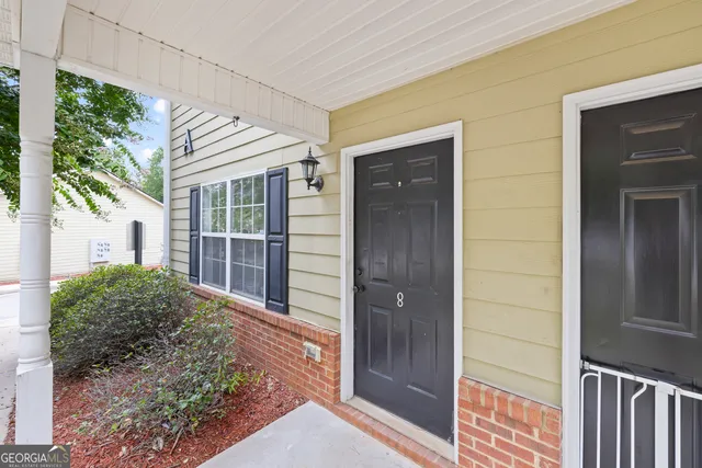a kitchen with a refrigerator sink and cabinets